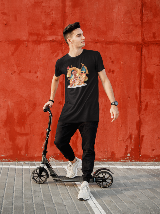 Man riding a scooter while wearing a black T-shirt with a design featuring Charizard, Charmander, and Charmeleon from Pokémon.