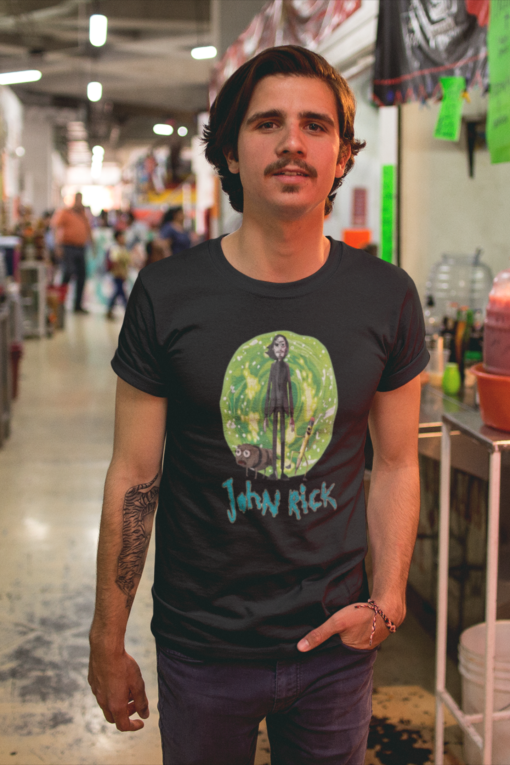 Man wearing a 'John Rick' t-shirt in a bustling indoor market.