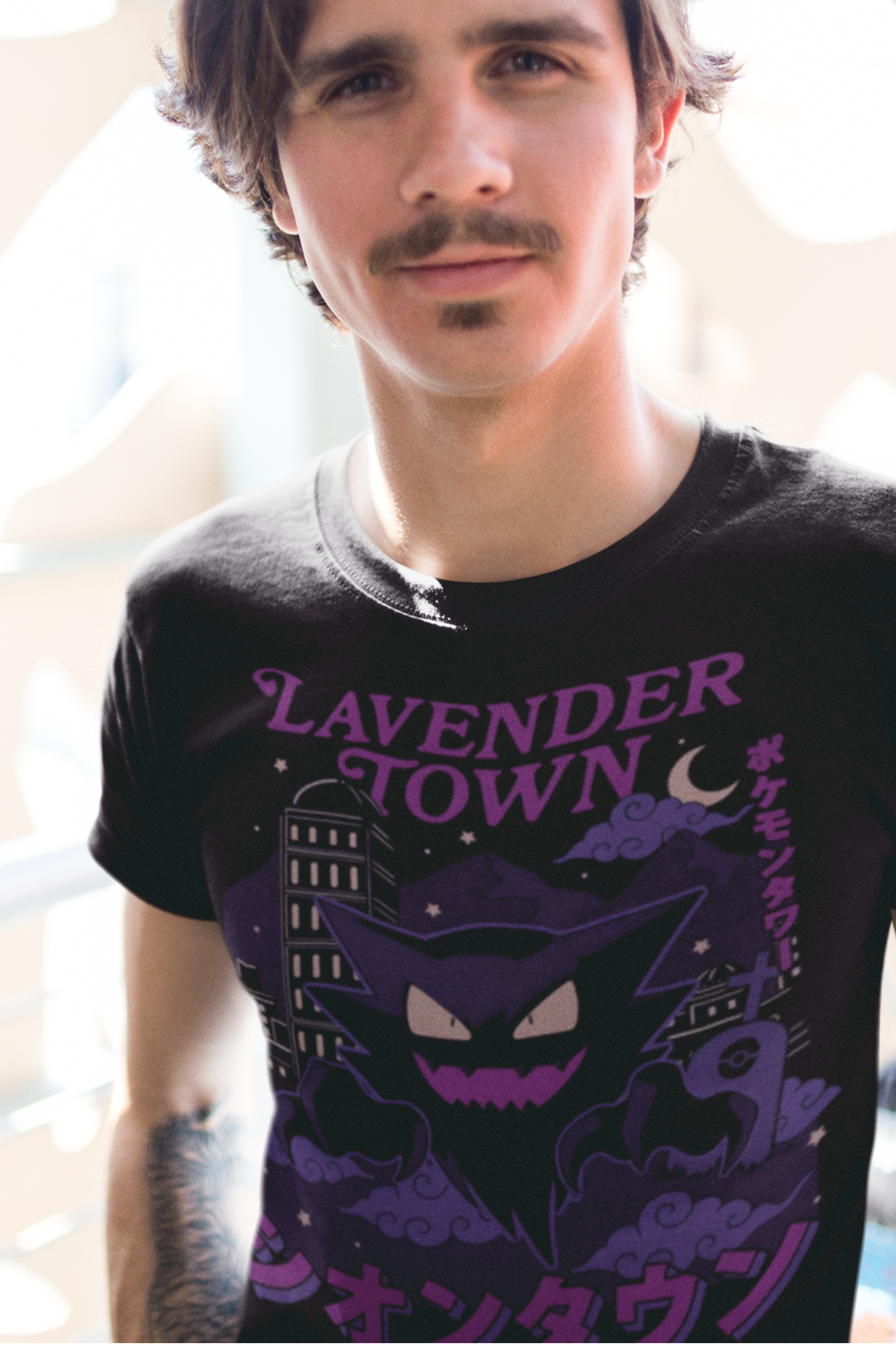 Close-up of Lavender Town Pokémon tee with haunted city and crescent moon artwork