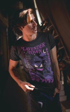 Man wearing black Lavender Town Pokémon tee featuring Haunter and spooky cityscape