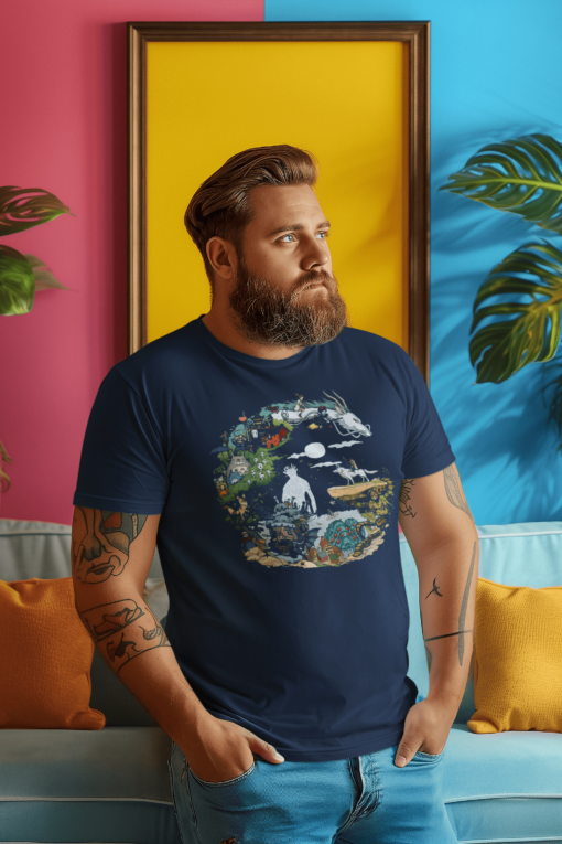 Bearded man wearing a navy t-shirt featuring a crescent moon-inspired design with Studio Ghibli characters, standing against a colorful pink and yellow wall.