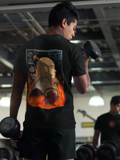 A man lifting weights in a gym while wearing a black Uncle Iroh-themed T-shirt. The design features Uncle Iroh surrounded by flames, a teapot, and elemental symbols from Avatar: The Last Airbender.