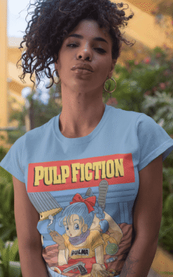 Curly-haired woman modeling Bulma Dragonball Pulp Fiction mashup t-shirt in an urban setting