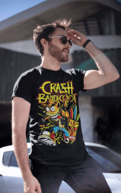 Man wearing Crash Bandicoot vintage band tee in an urban outdoor setting with sunglasses.