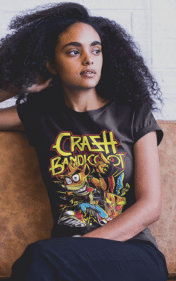 Woman wearing a black Crash Bandicoot casual t-shirt sitting on a leather chair indoors.