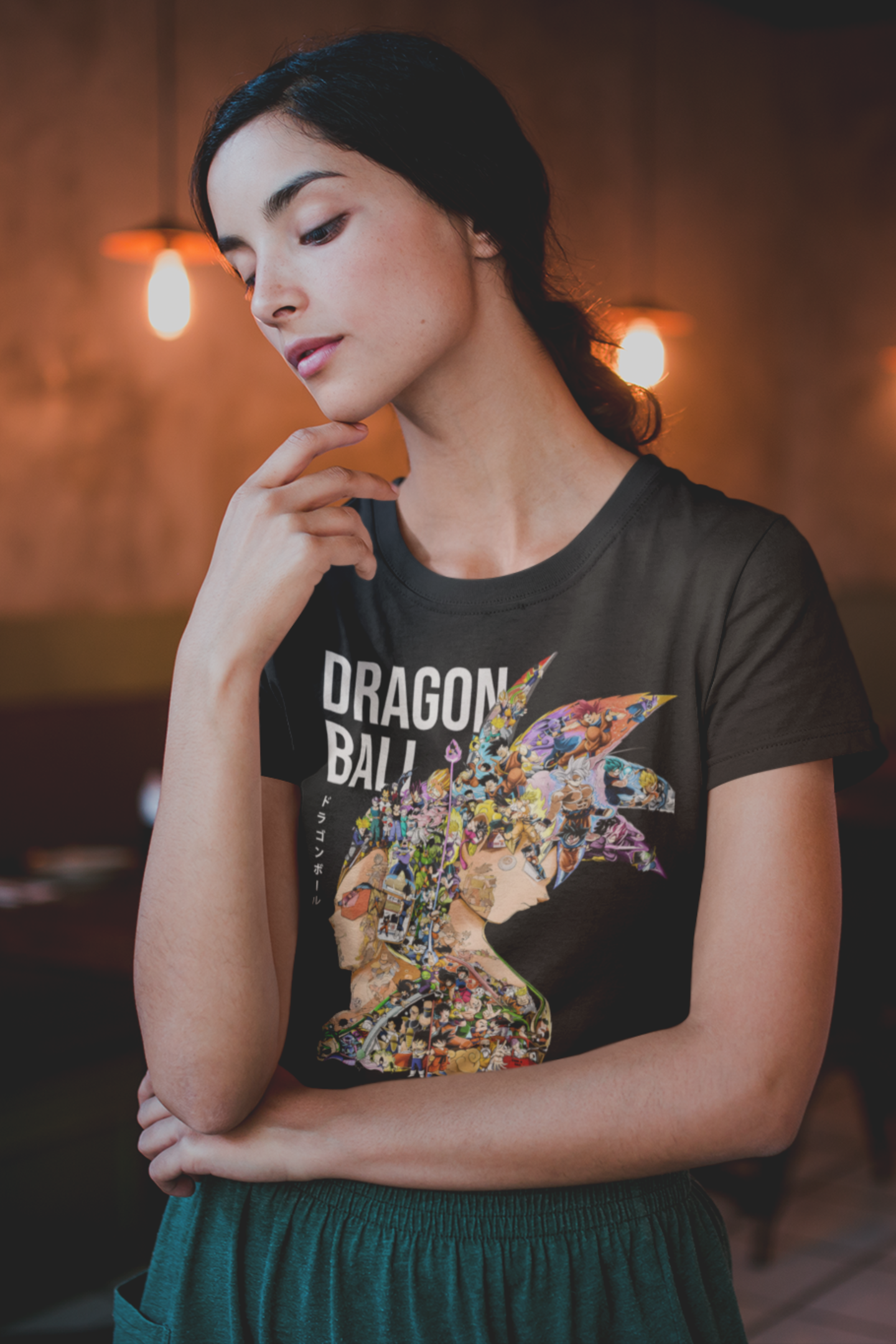 Female model in black Dragon Ball t-shirt featuring colorful montage of iconic Dragon Ball characters