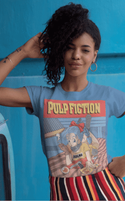 Young woman wearing Bulma Dragonball Pulp Fiction mashup t-shirt with blue top, outdoors