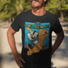 Smiling male model wearing Super Adventureworld black tee with Mario and Jake, sunglasses on, standing on a sunny beach.
