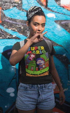 Woman posing in black Super Mario t-shirt against graffiti wall background