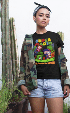 Close-up of woman wearing black Super Mario unisex t-shirt with camo jacket, showing detailed retro gaming design