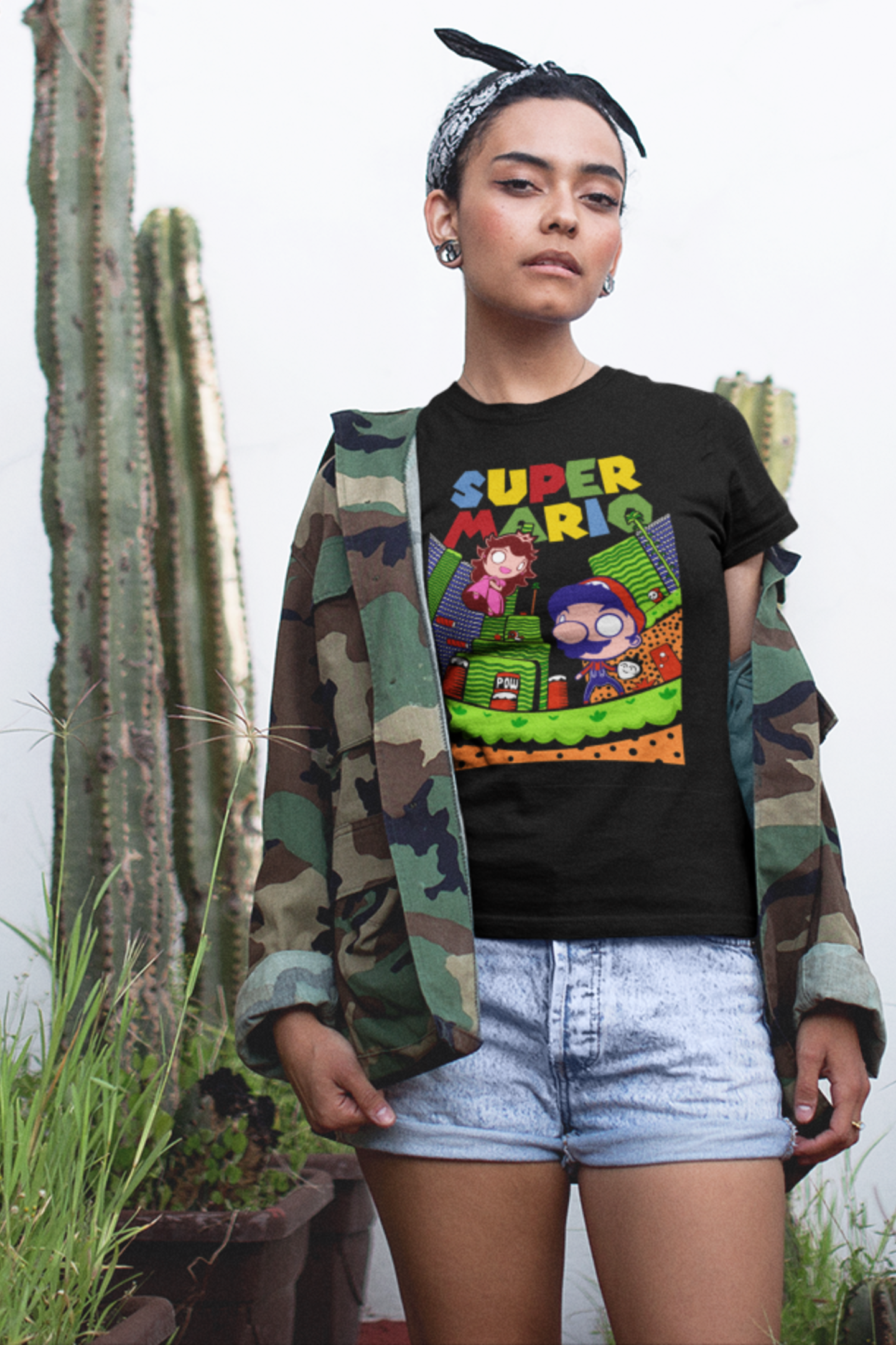 Close-up of woman wearing black Super Mario unisex t-shirt with camo jacket, showing detailed retro gaming design