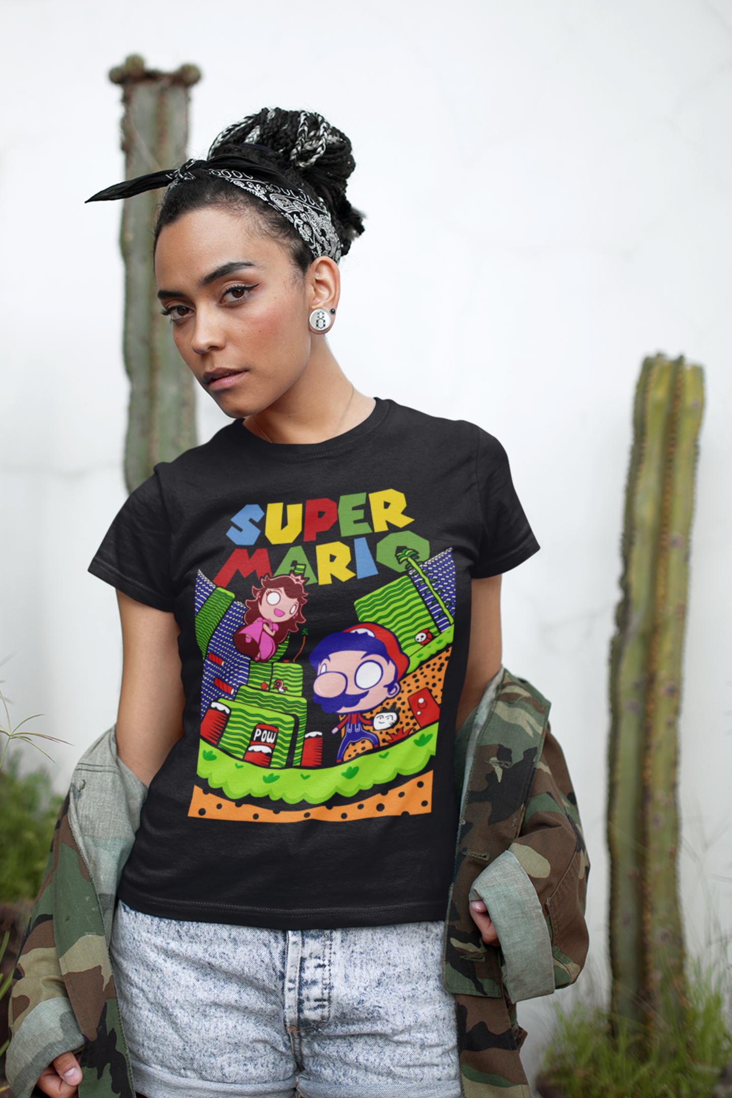 Woman wearing black Super Mario unisex t-shirt with camo jacket and vintage gaming style design
