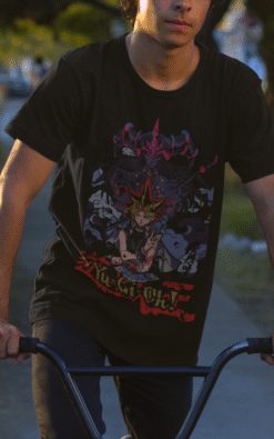 Male BMX rider outdoors wearing black Yu-Gi-Oh! duel monster graphic t-shirt